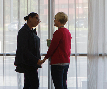 white woman and black woman talk to eachother
