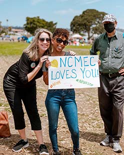 NCMEC CEO and staff member holding thank sign