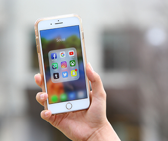 white hand caucasian holding smartphone iphone with apps social media open