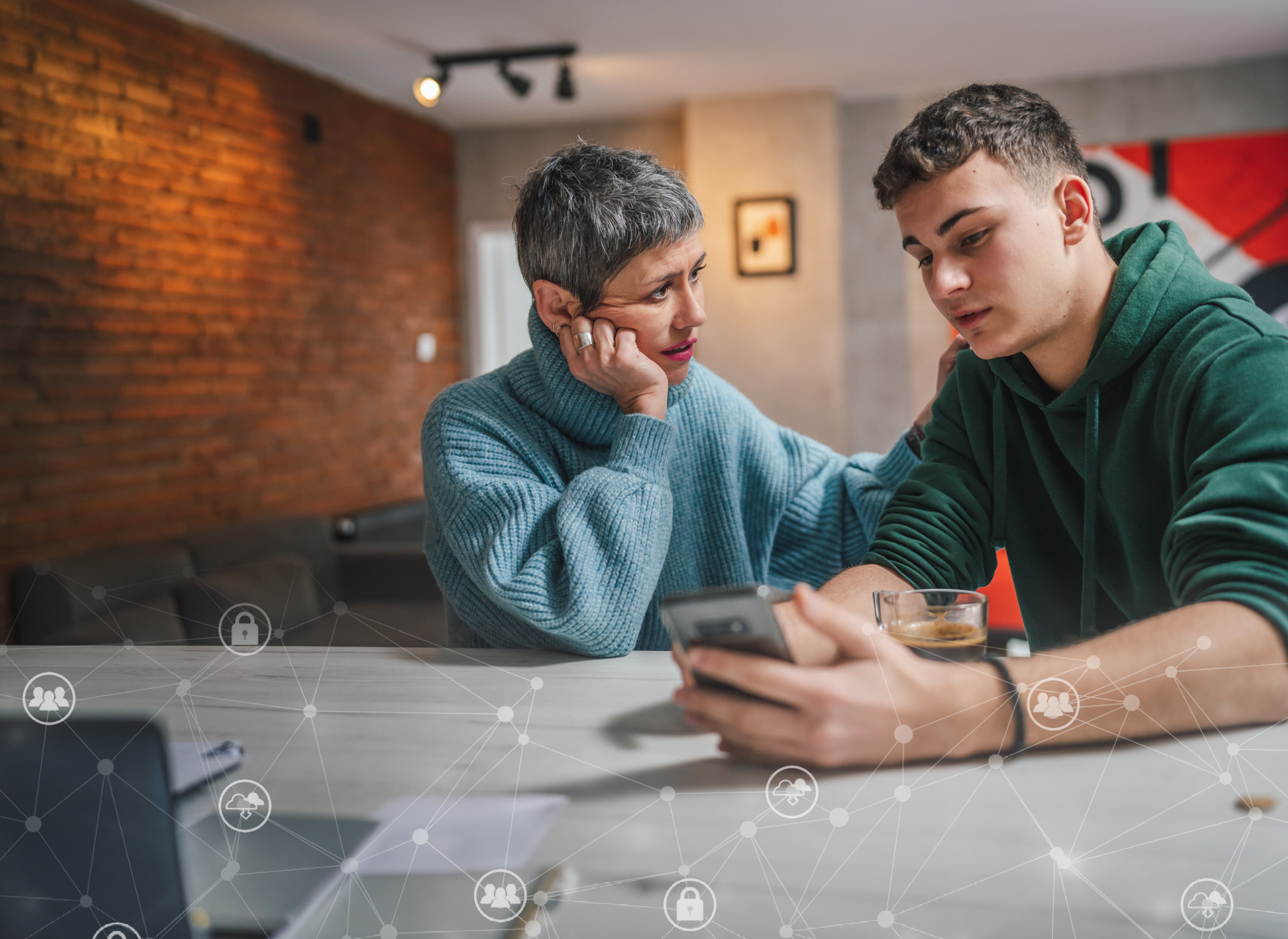 a parent talks to their teenage son, who is holding a cell phone