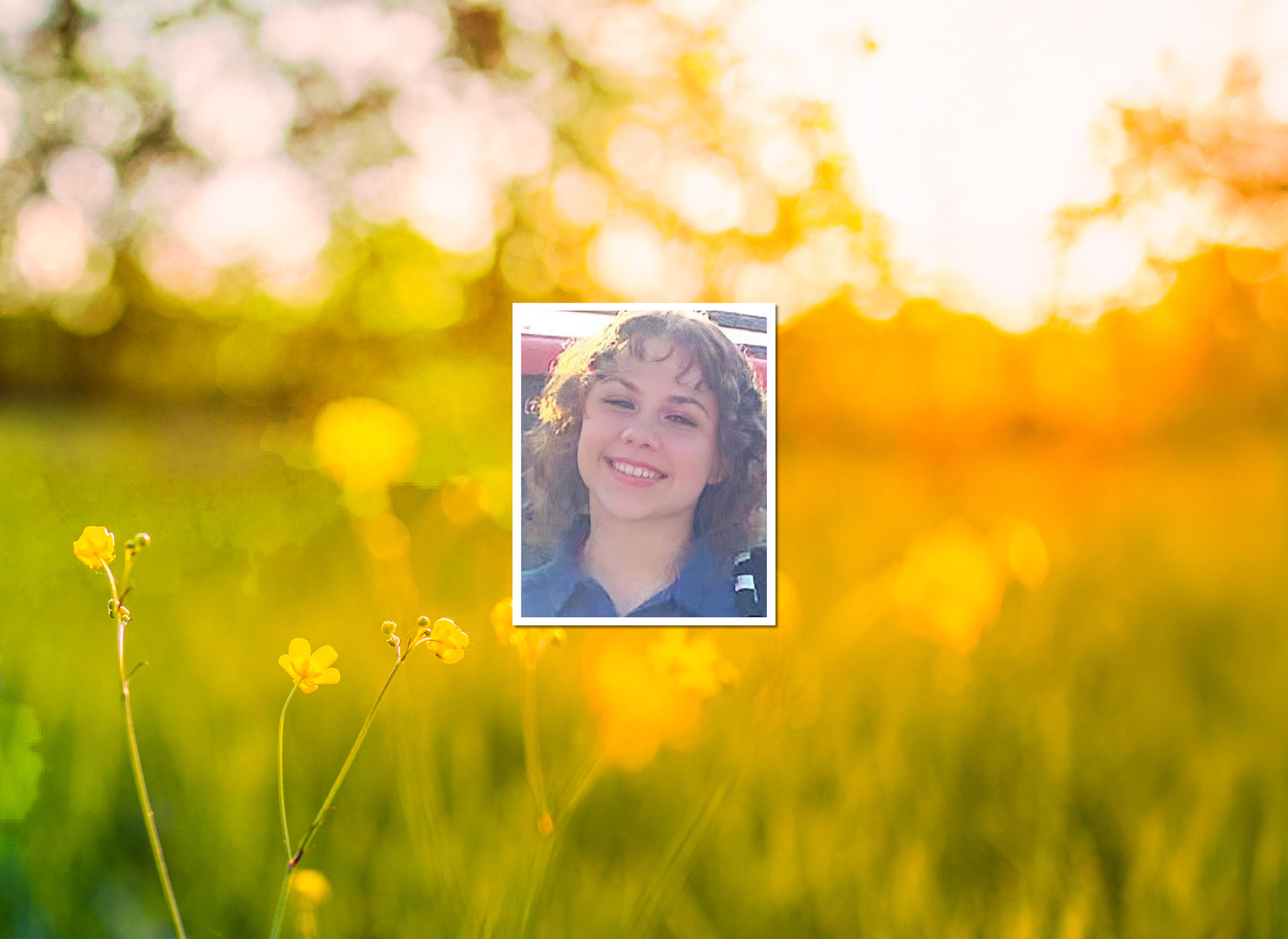 image of teen girl smiling with curly hair, background wildflowers