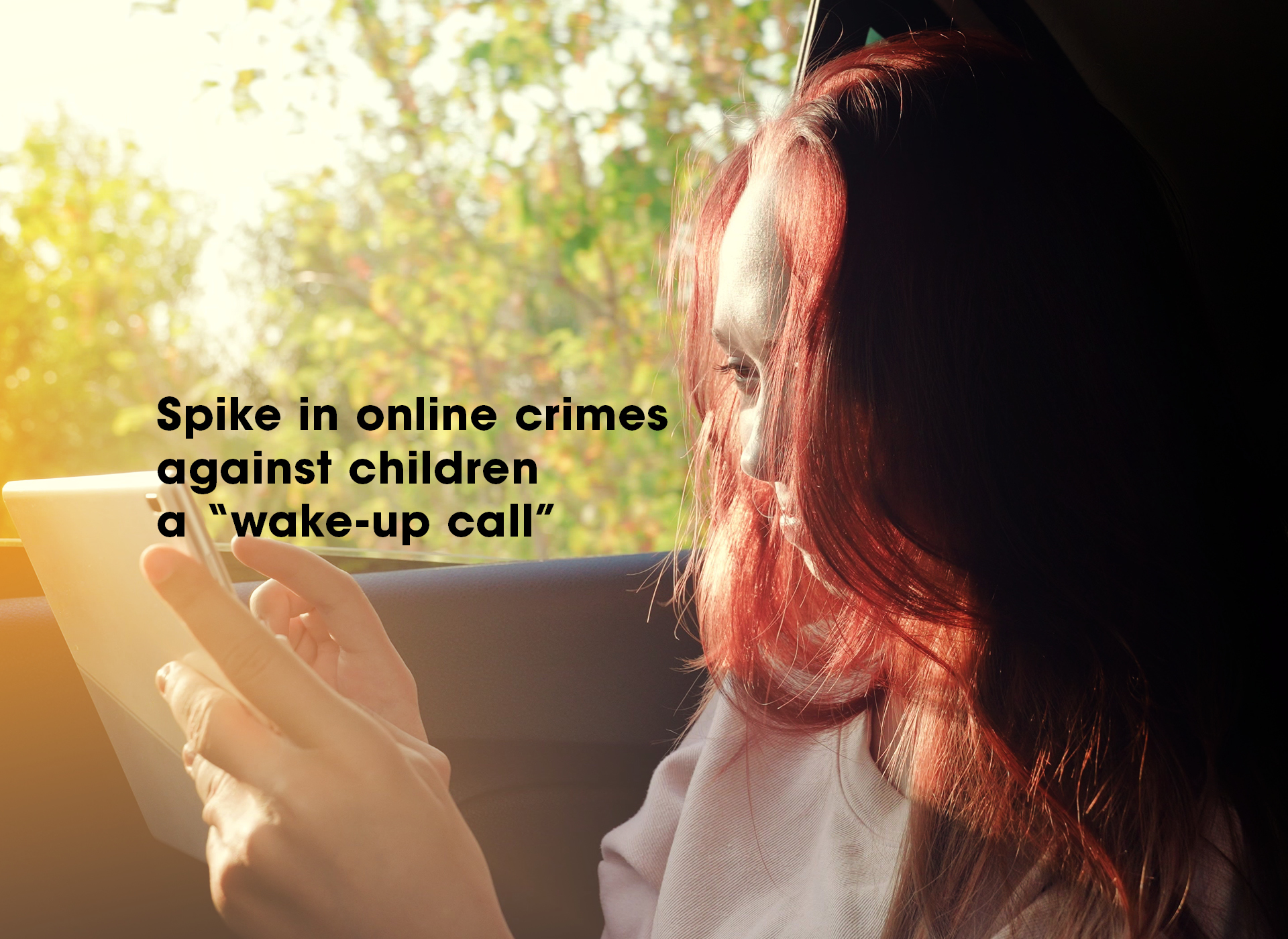 teen girl with dark hair looks at cell phone