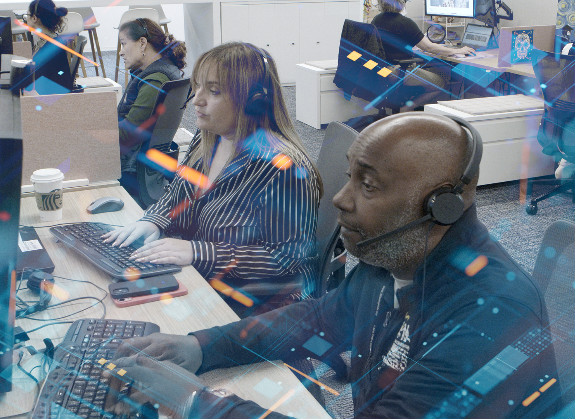 three ncmec employees sit at their desk responding to children and families in  need