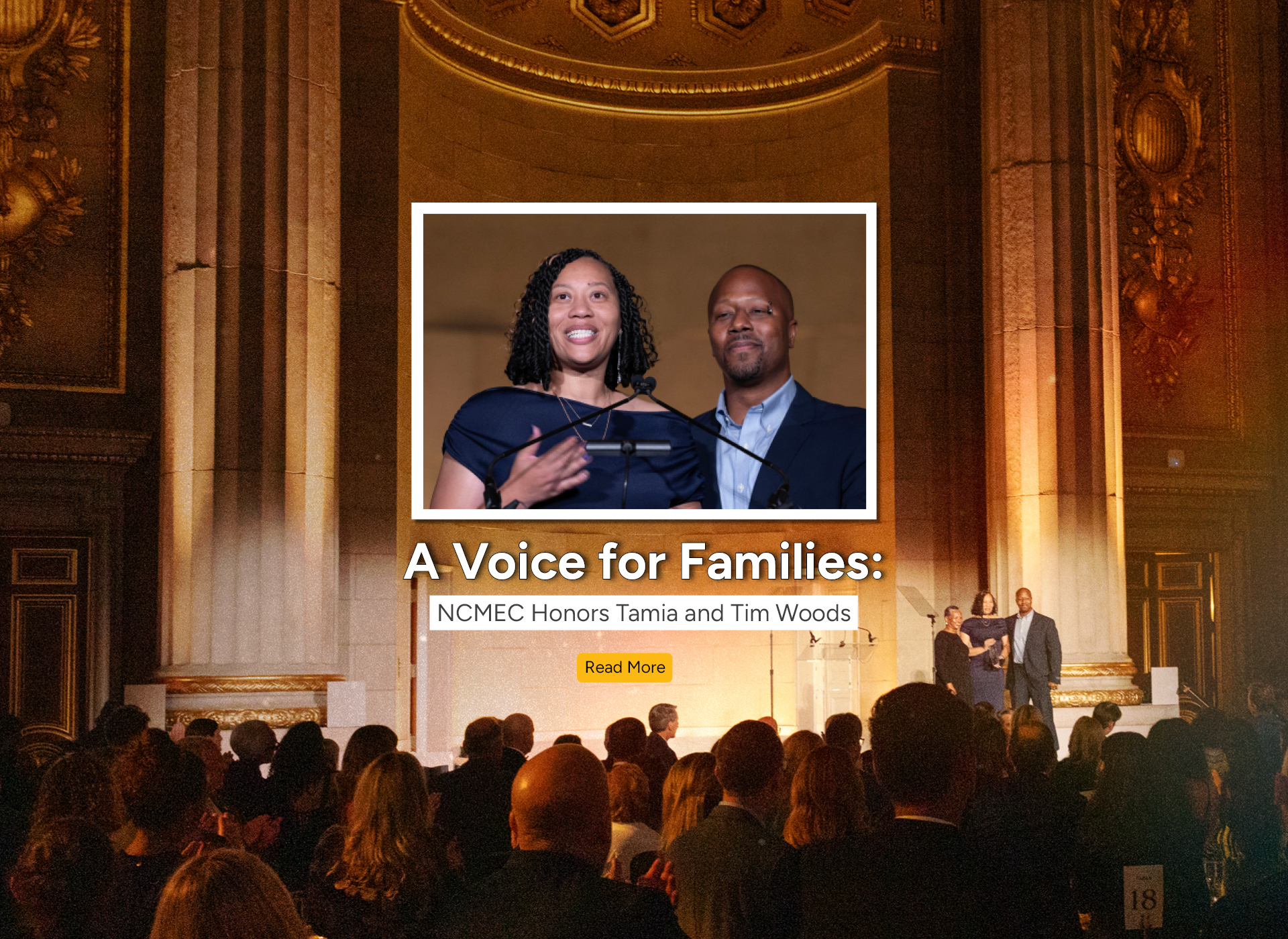 a couple stands on a stage in front of an audience
