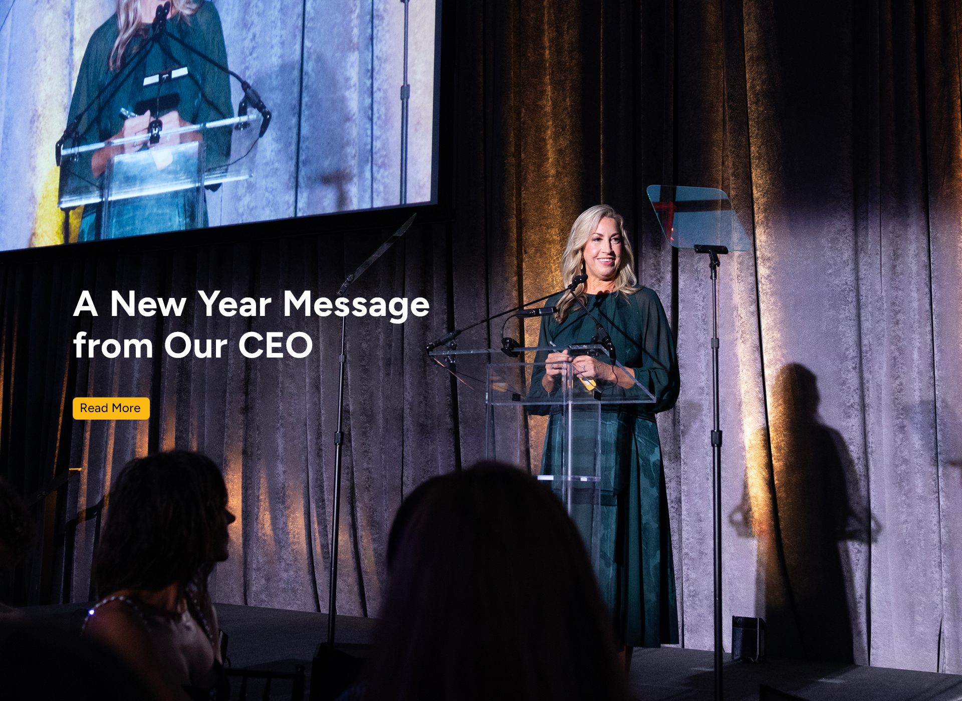 michelle wears black dress and speaks from a podium